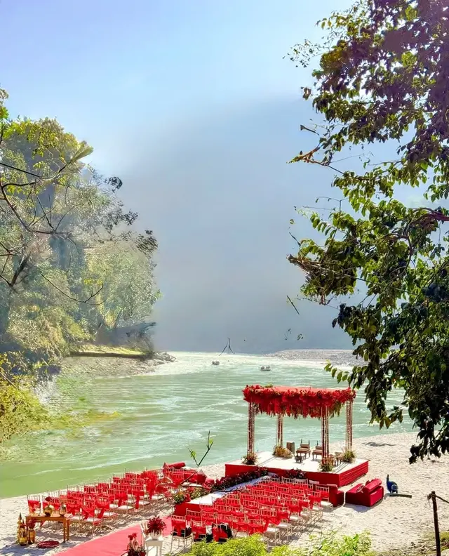 Varmala moment at a riverside destination wedding