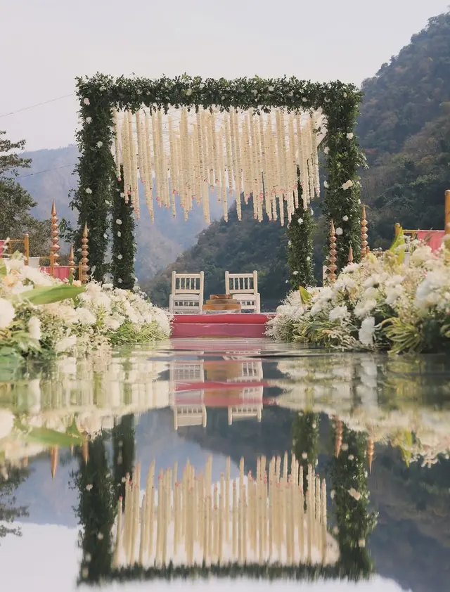 Bride and groom at a riverside wedding mandap