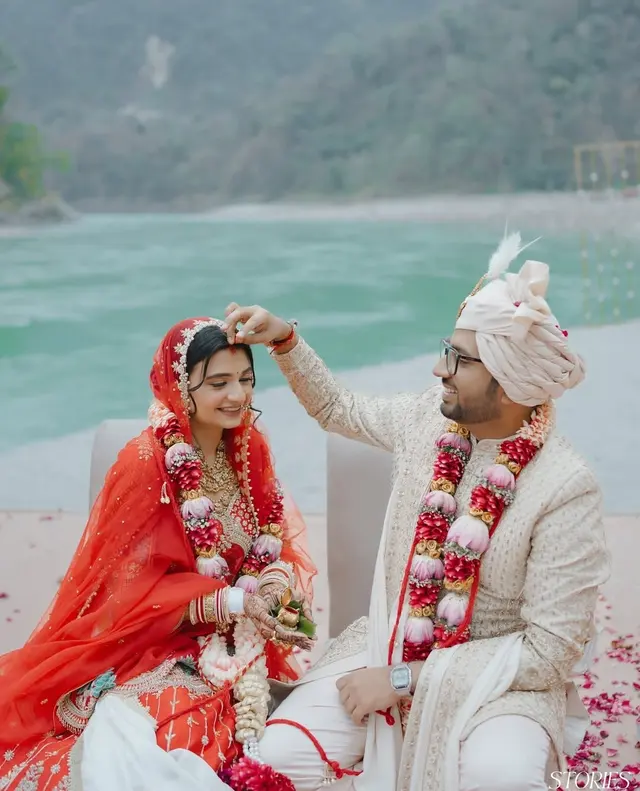 Draped floral mandap at a riverside wedding